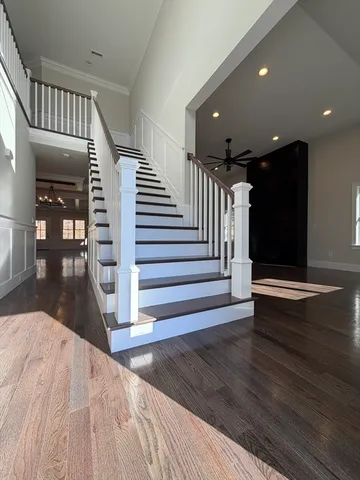 a view of entryway and hall with wooden floor