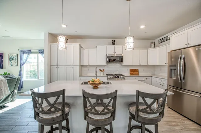 a white stove top oven sitting inside of a kitchen