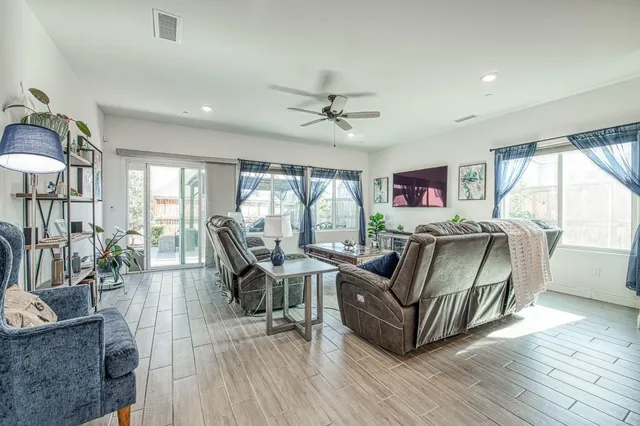 a living room with furniture and a wooden floor