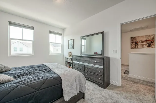 a living room with furniture a air conditioner vent and a window