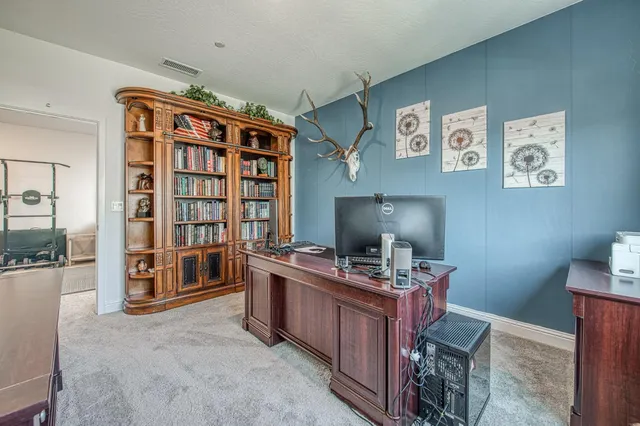 a patio with table and chairs and potted plants
