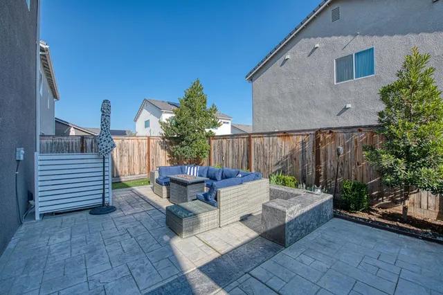 a view of a patio with couches chairs and wooden floor