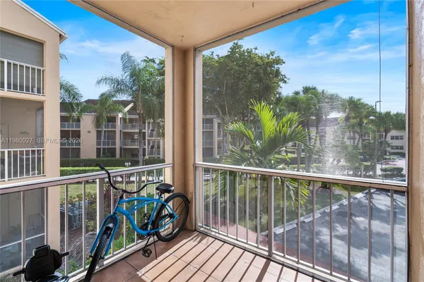 a view of a balcony with floor to ceiling windows with wooden floor