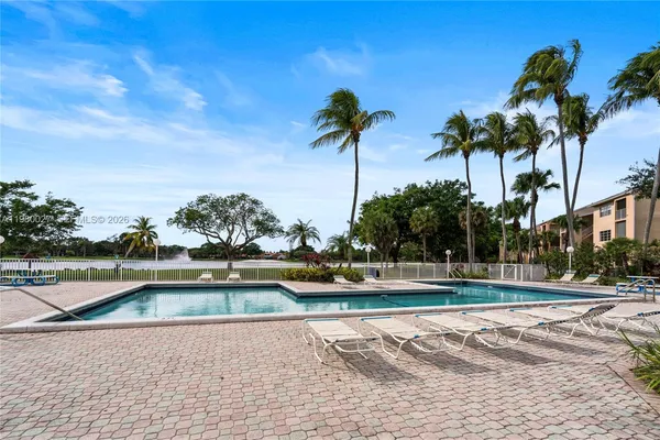 a view of a swimming pool and a yard