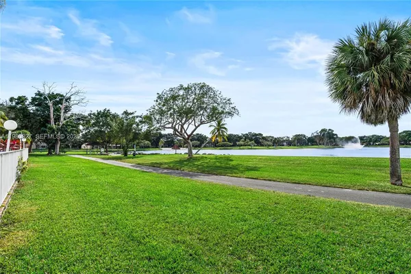 a view of a park and trees in the background