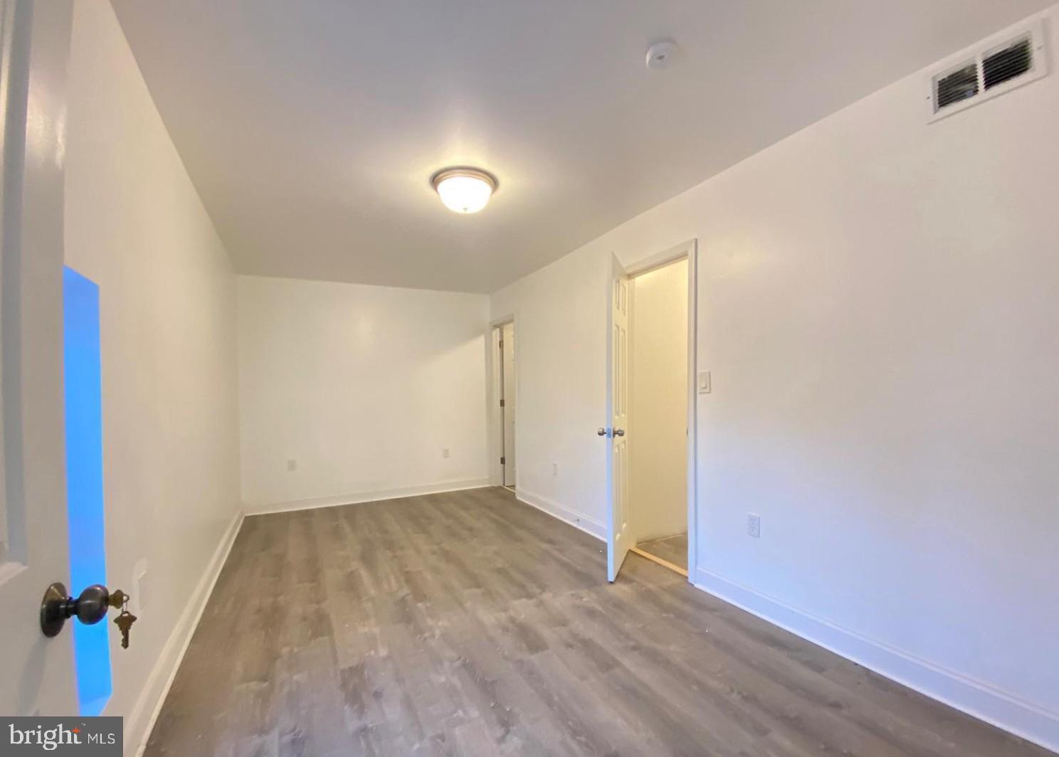1230 North 15th Street Philadelphia, PA 19121 - Photo 11 of 31 an empty room with wooden floor and windows