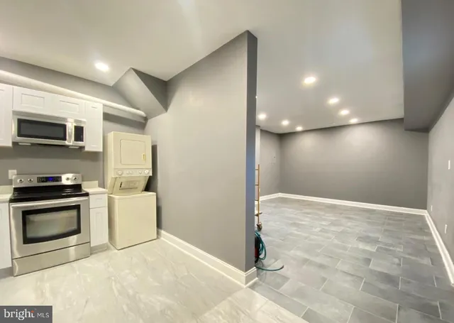 a view of a kitchen with a stove cabinets and a wooden floor