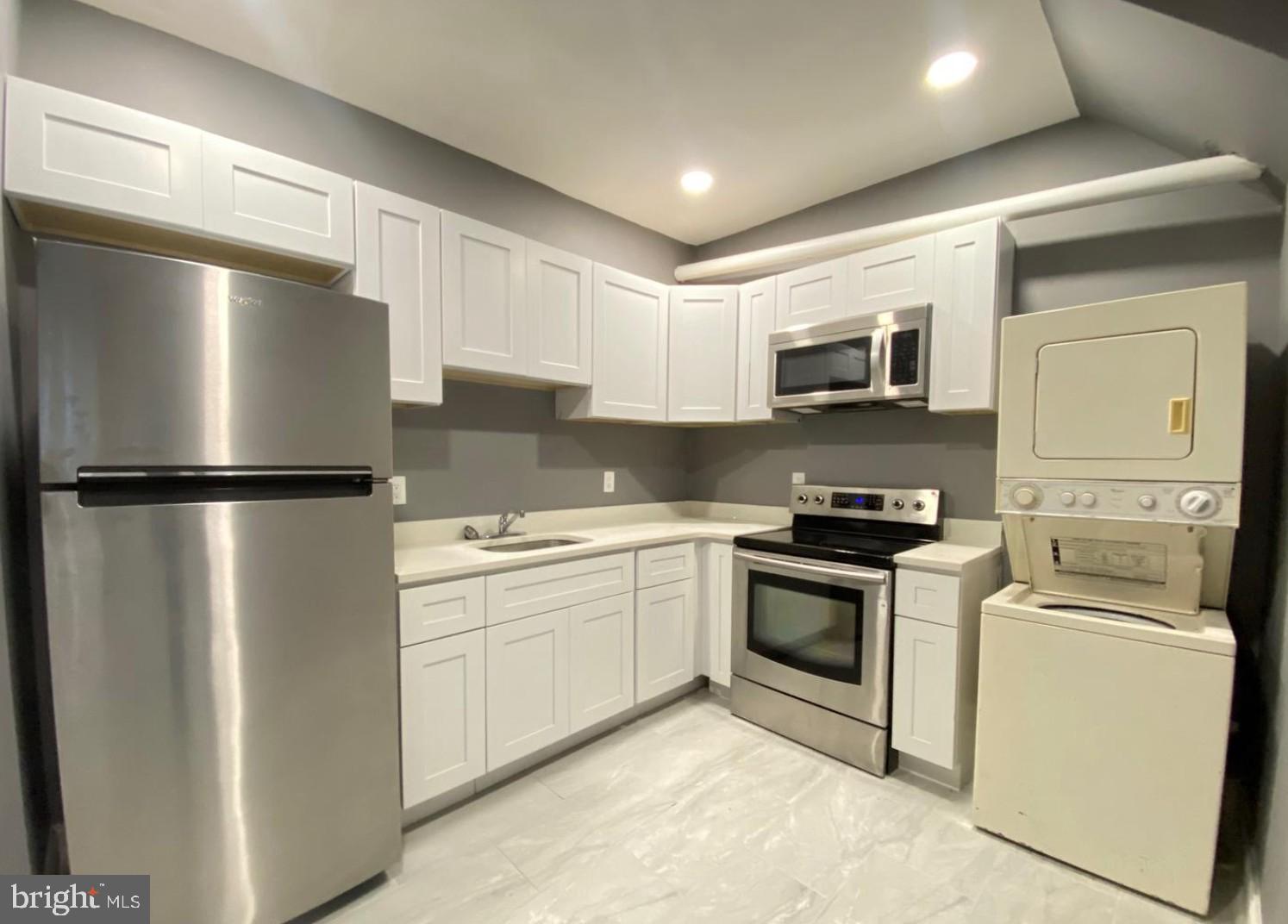 1230 North 15th Street Philadelphia, PA 19121 - Photo 16 of 31 a kitchen with a refrigerator stove and sink