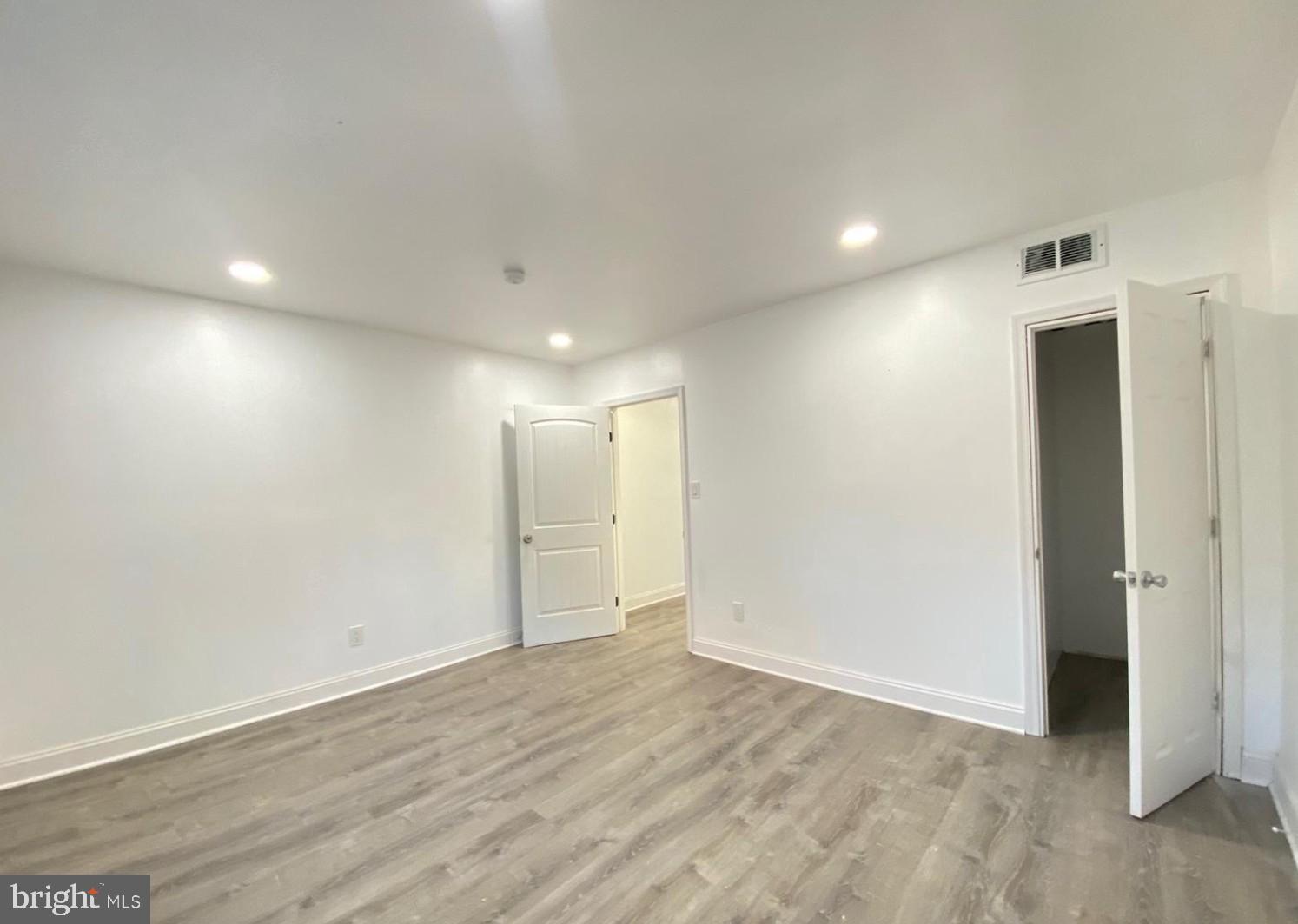 1230 North 15th Street Philadelphia, PA 19121 - Photo 10 of 31 an empty room with wooden floor and windows