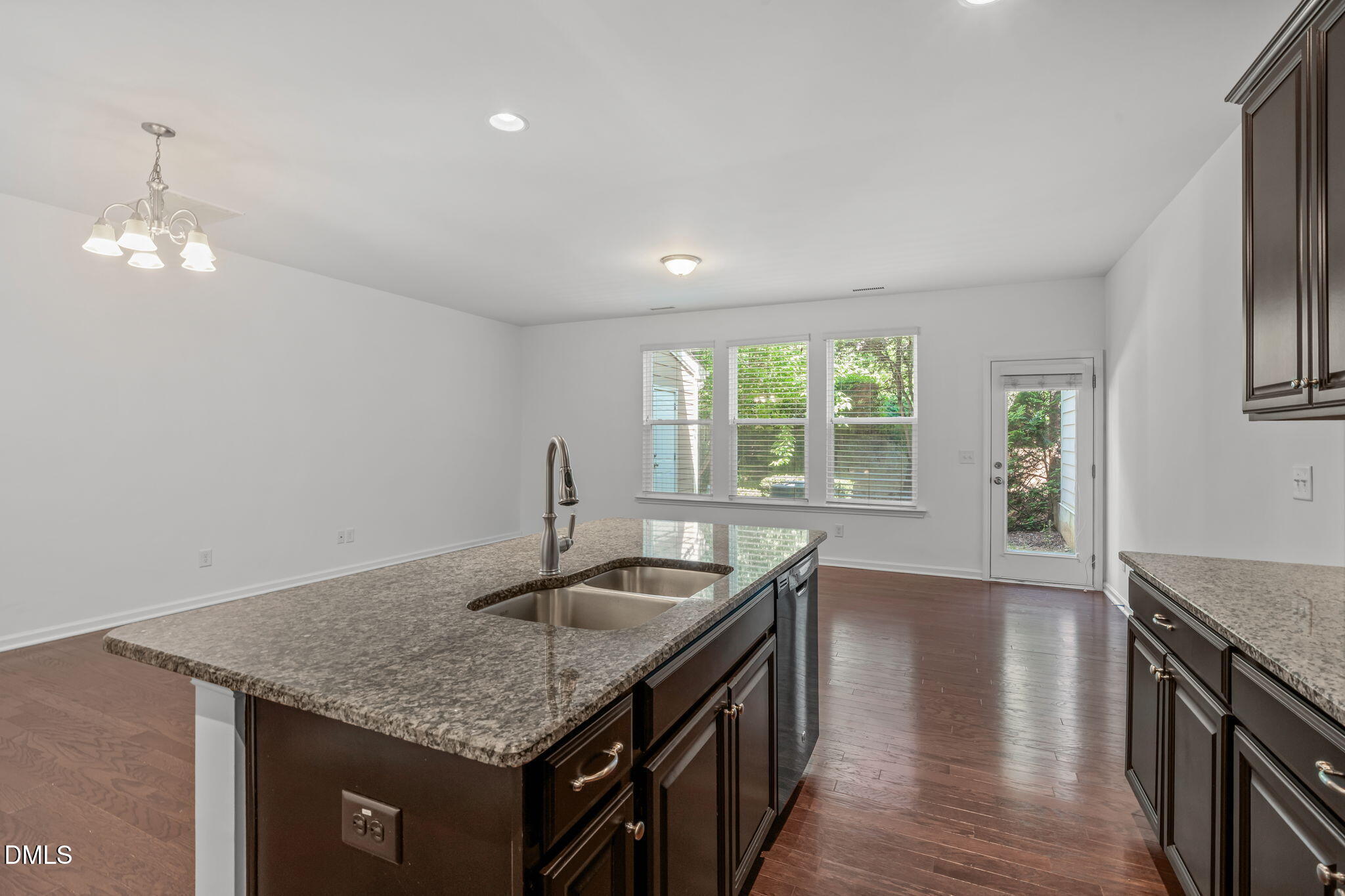 102 Ransomwood Drive Apex, NC 27539 - Photo 11 of 34 a kitchen with stainless steel appliances granite countertop a sink dishwasher and stove with wooden floor