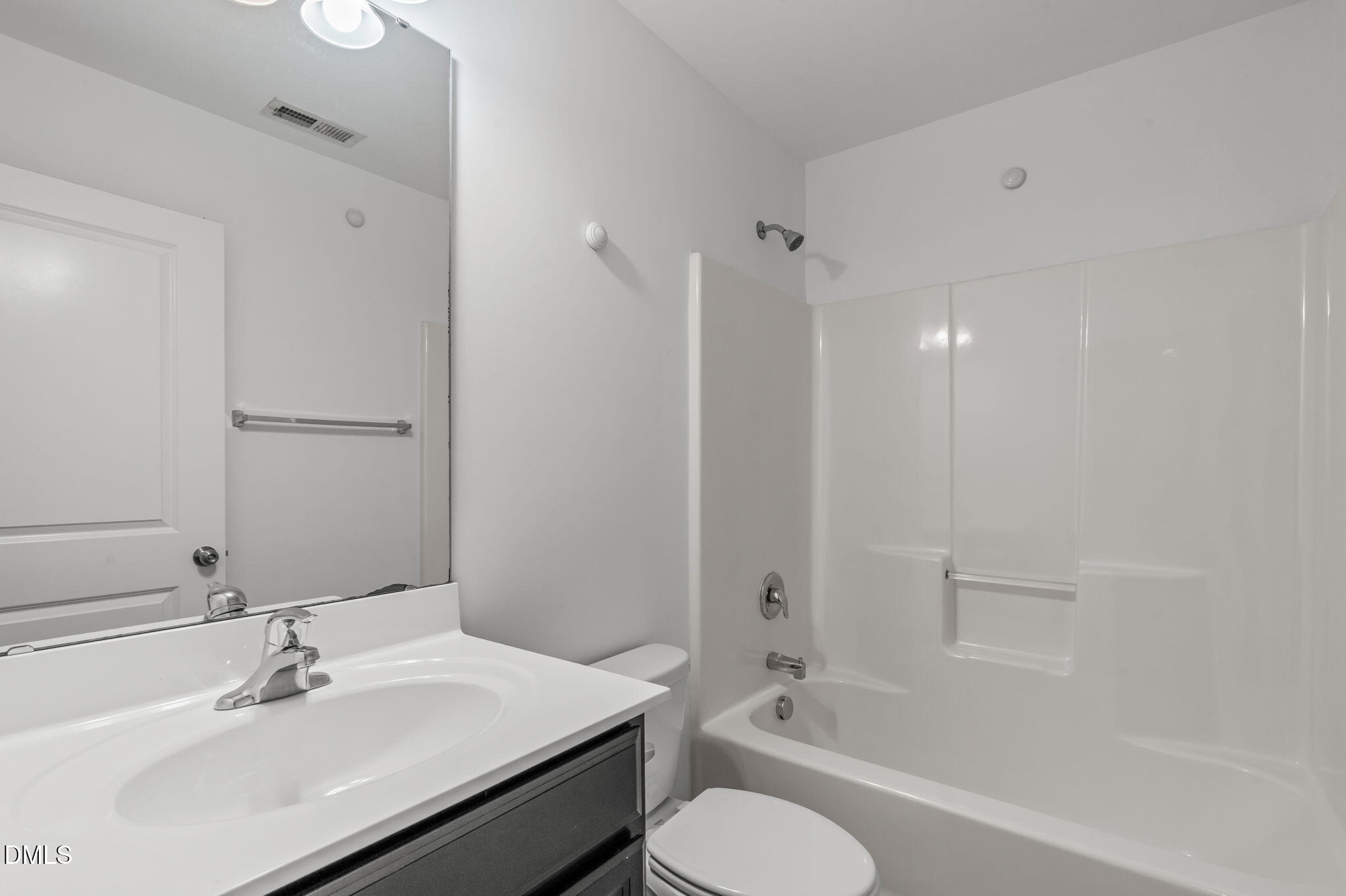 102 Ransomwood Drive Apex, NC 27539 - Photo 19 of 34 a bathroom with a bathtub shower sink vanity mirror and toilet