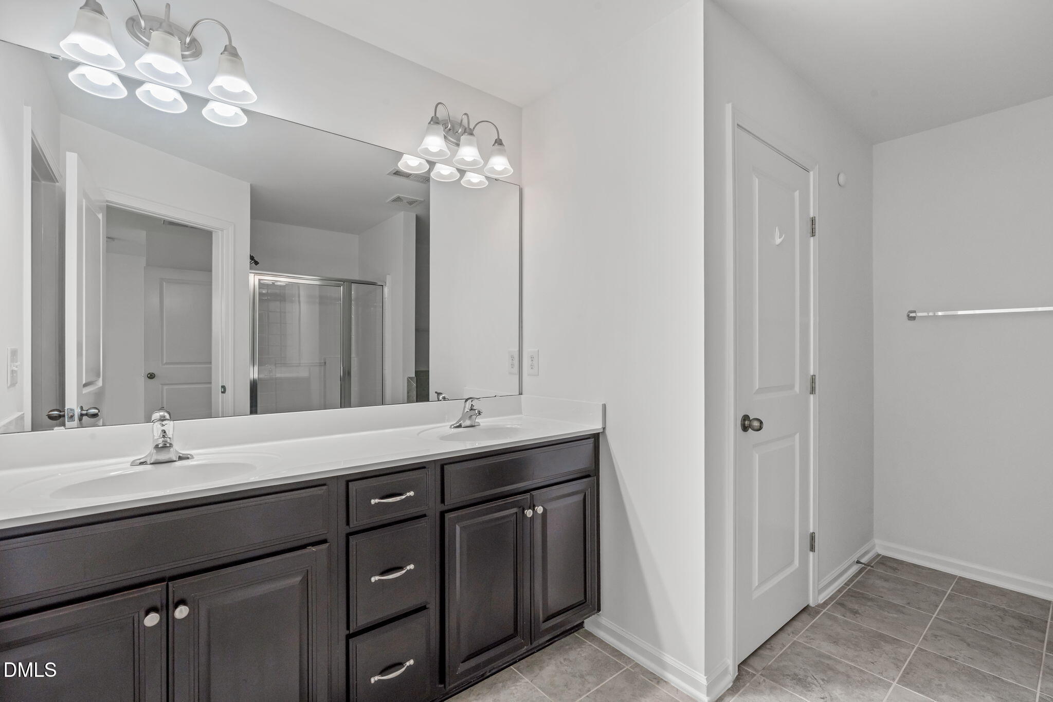 102 Ransomwood Drive Apex, NC 27539 - Photo 25 of 34 a bathroom with a double vanity sink and a mirror