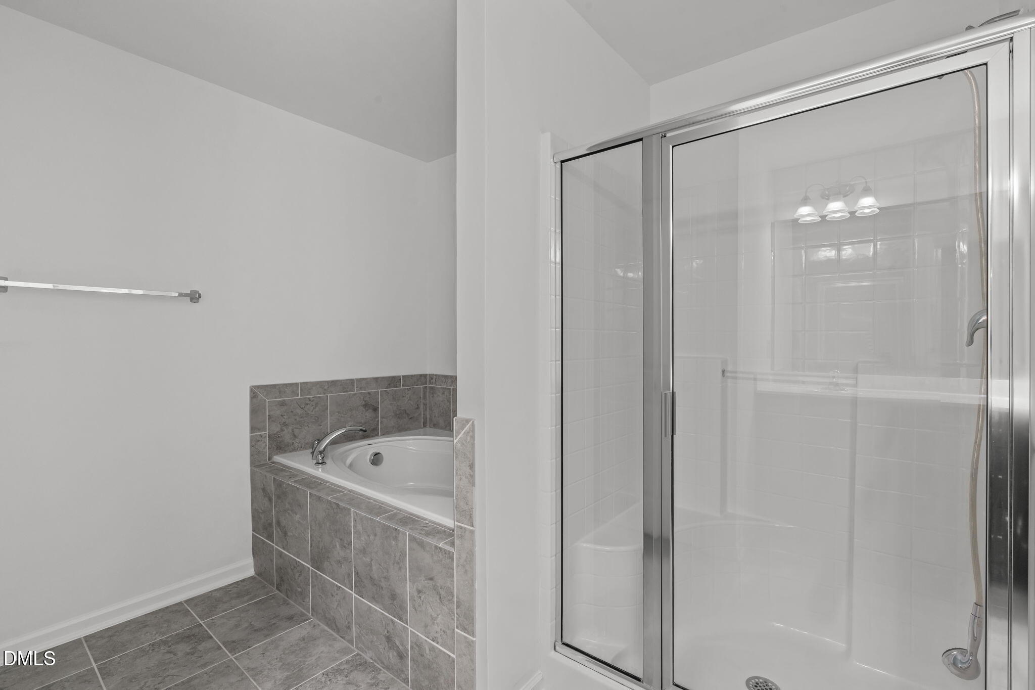 102 Ransomwood Drive Apex, NC 27539 - Photo 26 of 34 a bathroom with a tub a sink and a shower
