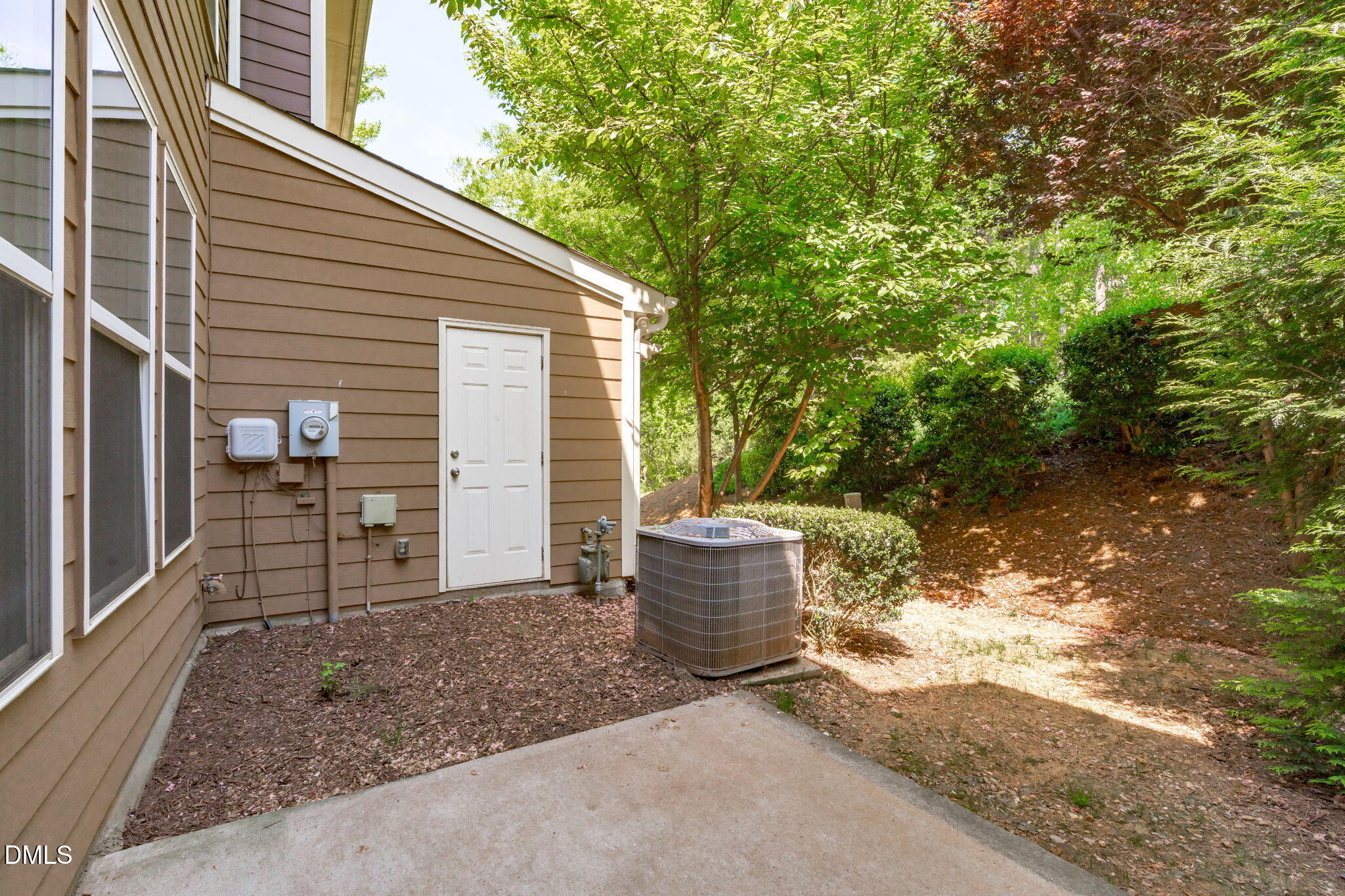 102 Ransomwood Drive Apex, NC 27539 - Photo 29 of 34 a backyard of a house with fountain plants and large tree