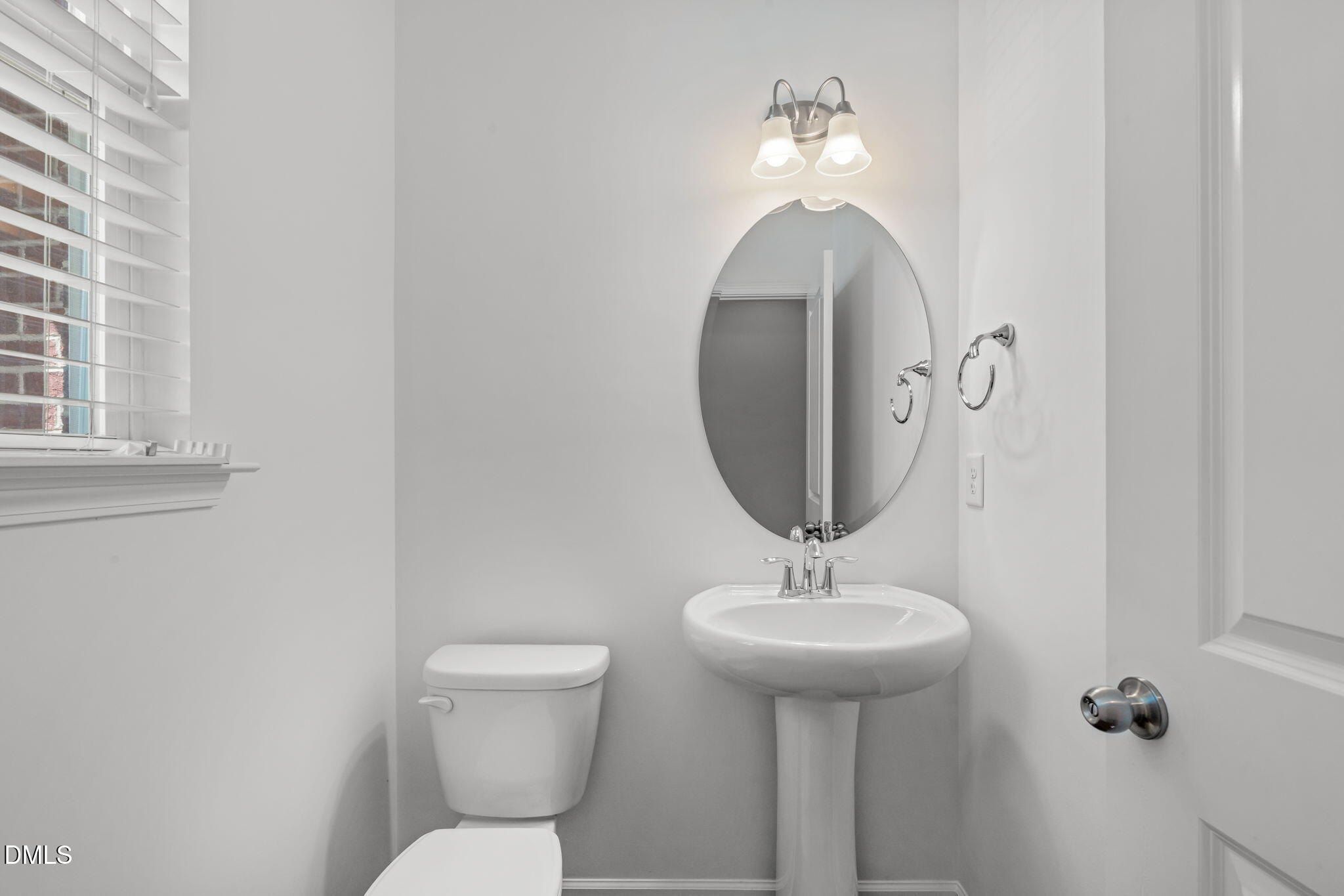 102 Ransomwood Drive Apex, NC 27539 - Photo 5 of 34 a bathroom with a toilet sink and mirror