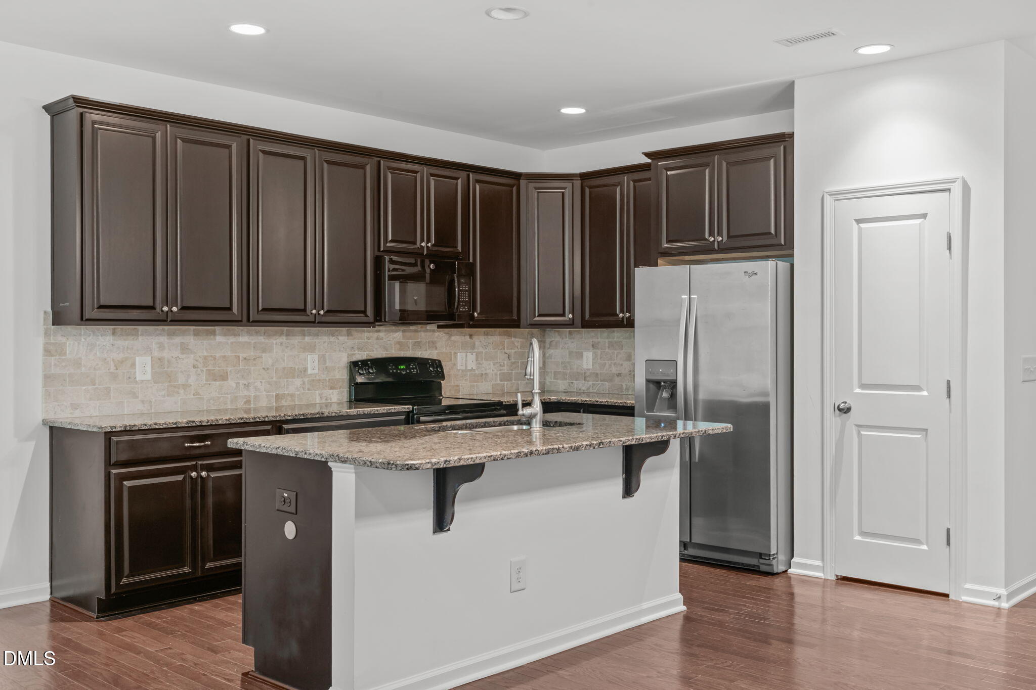 102 Ransomwood Drive Apex, NC 27539 - Photo 8 of 34 a kitchen with a refrigerator sink and cabinets