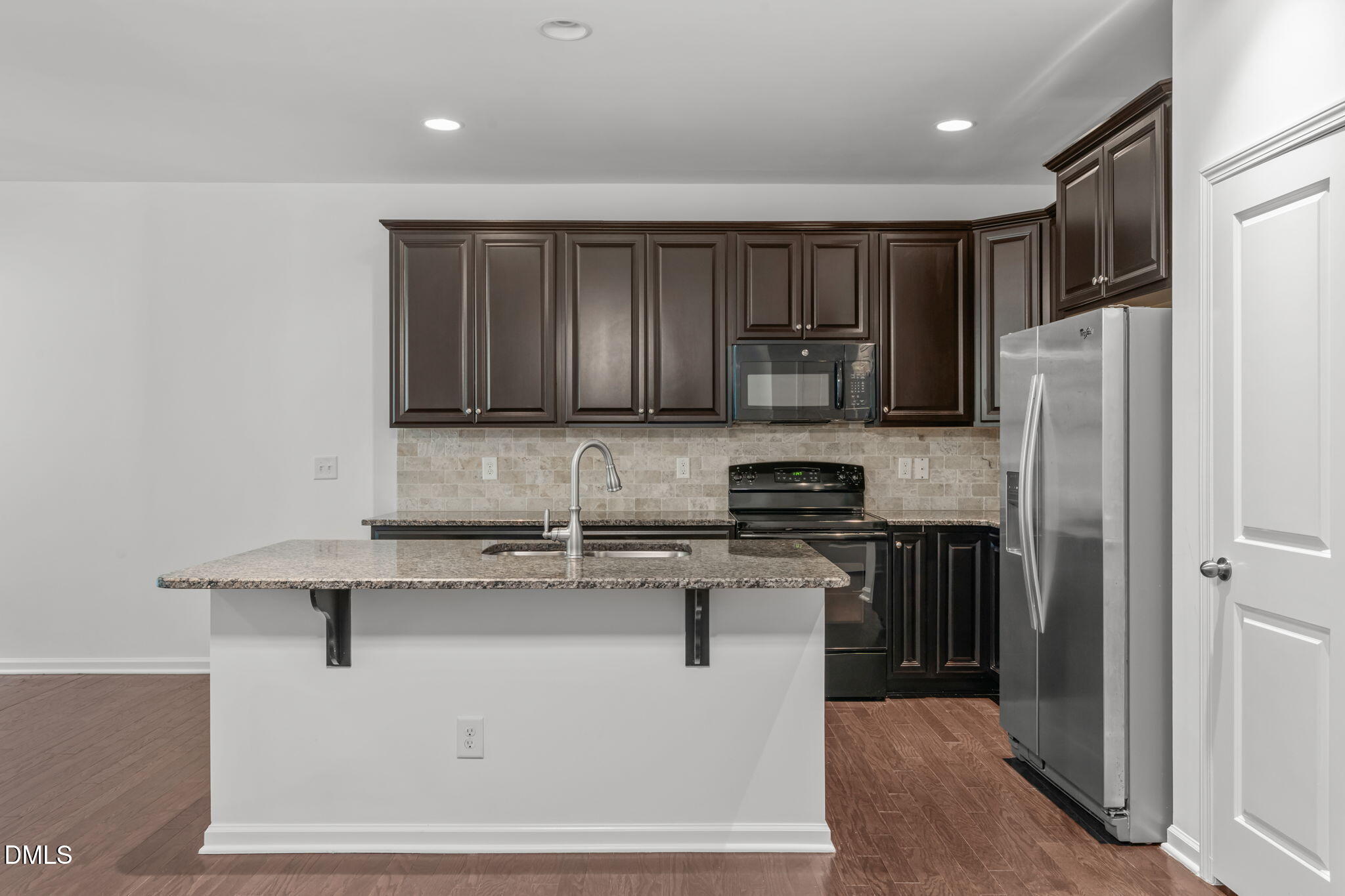 102 Ransomwood Drive Apex, NC 27539 - Photo 9 of 34 a kitchen with stainless steel appliances granite countertop a refrigerator stove a sink and dishwasher