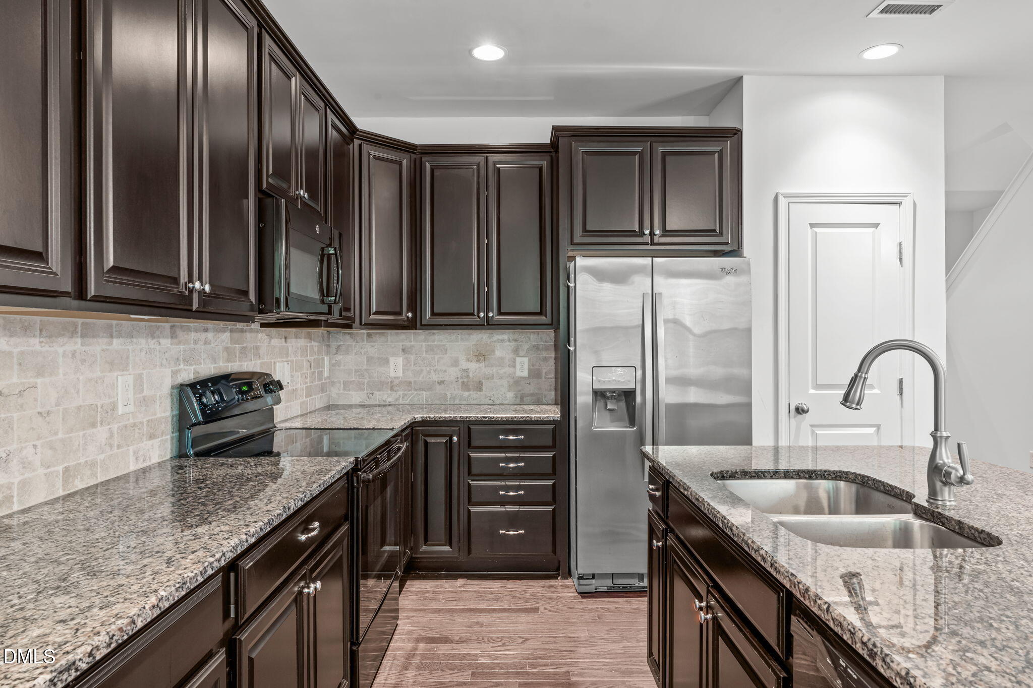 102 Ransomwood Drive Apex, NC 27539 - Photo 10 of 34 a kitchen with granite countertop a sink a stove and cabinets