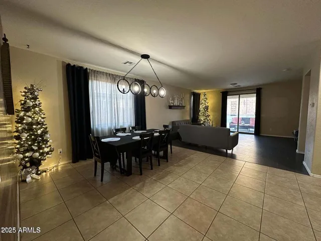 a lobby with furniture and chandelier