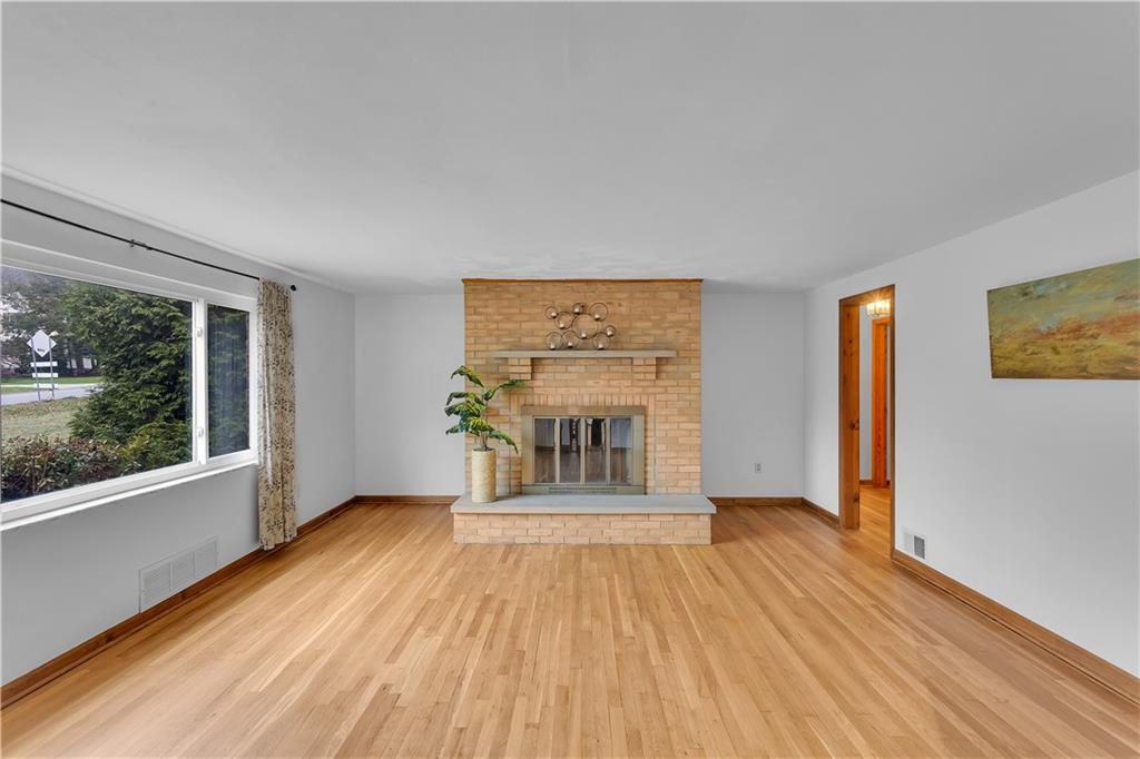 9167 Hubbard Road Allison Park, PA 15101 - Photo 4 of 35 Beautiful Family Room with a brick wood burning fireplace. Large picture window to let in natural light and enjoy wonderful views. Handsome refinished wood floors.