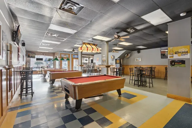 a kitchen with stainless steel appliances granite countertop a sink a stove and a refrigerator