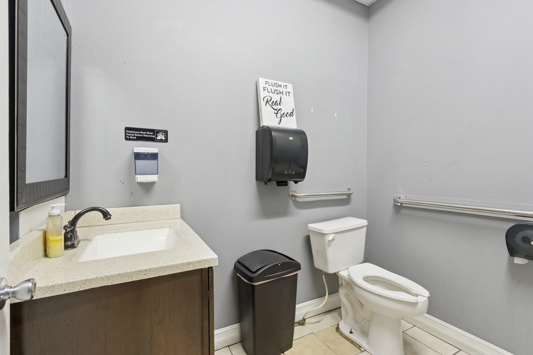 522 South State Street Belvidere, IL 61008 - Photo 29 of 67 a bathroom with a toilet a sink and mirror