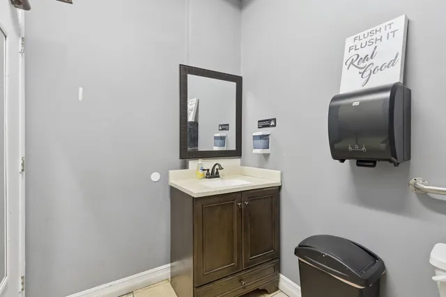 a living room with furniture and a open kitchen view