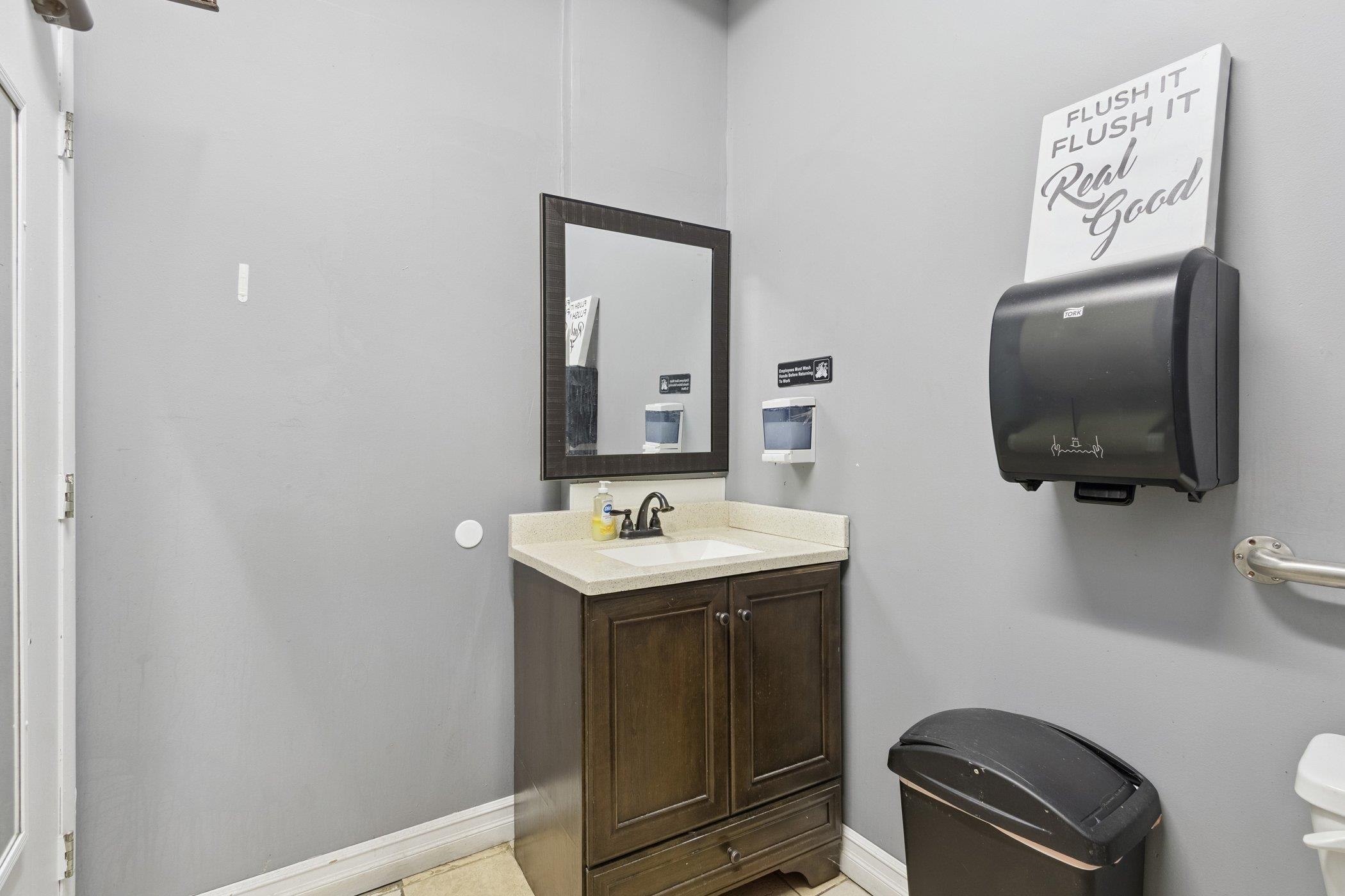 522 South State Street Belvidere, IL 61008 - Photo 30 of 67 a bathroom with a toilet a sink and mirror