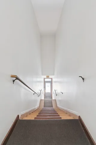 a living room with furniture a clock on wall and a table