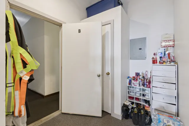 a kitchen with stainless steel appliances kitchen island granite countertop a sink and a refrigerator