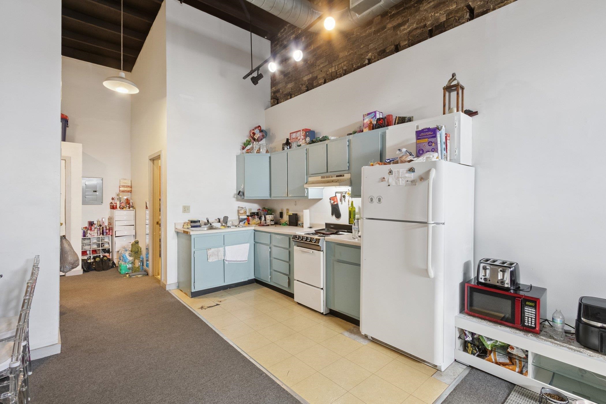 522 South State Street Belvidere, IL 61008 - Photo 34 of 67 a kitchen with refrigerator and cabinets