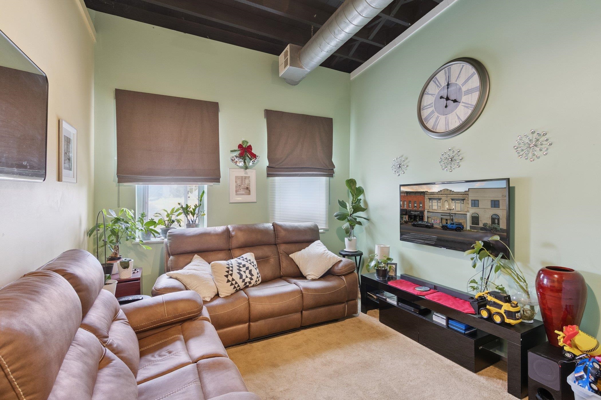 522 South State Street Belvidere, IL 61008 - Photo 44 of 67 a living room with furniture a clock and a flat screen tv