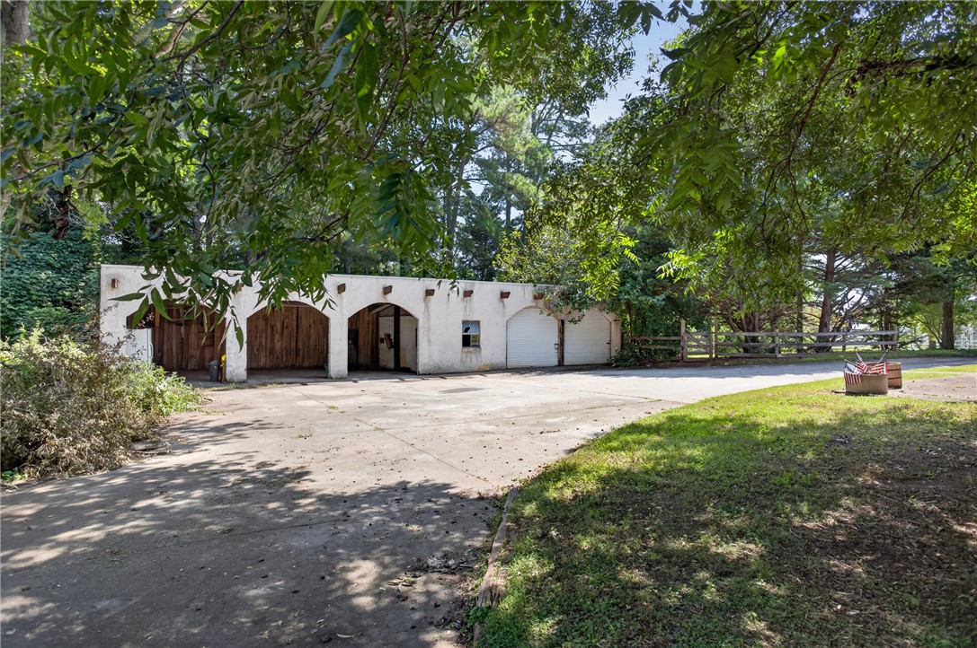 1719 Old Central Road Central, SC 29630 - Photo 11 of 45 Mature trees shade a spacious concrete parking area and a unique multi-bay outbuilding.