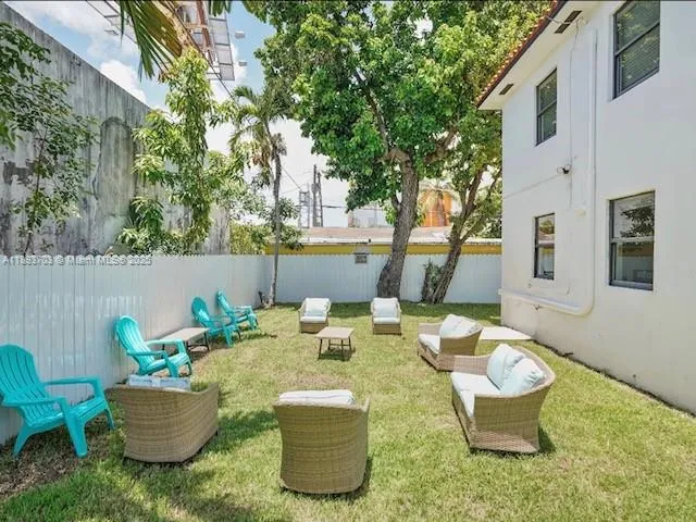 a view of a backyard with table and chairs