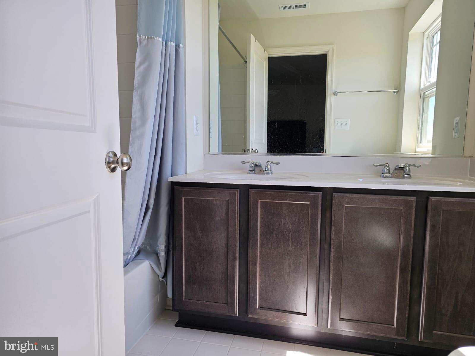 2506 Boeing Way Cambridge, MD 21613 - Photo 13 of 19 a bathroom with a granite countertop sink and a mirror