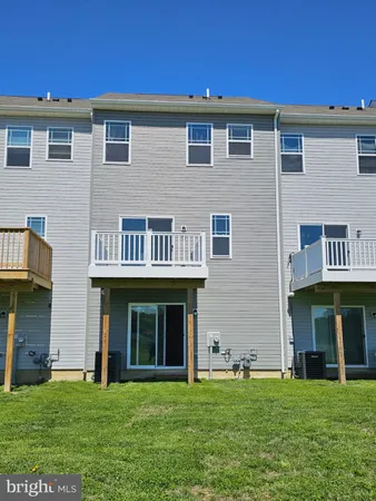 a front view of a brick building with a yard