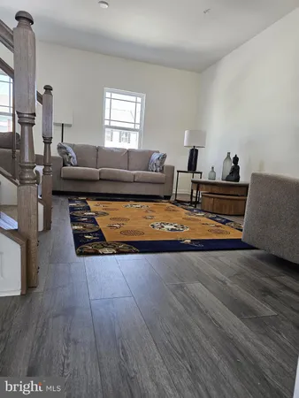 a living room with furniture and a rug