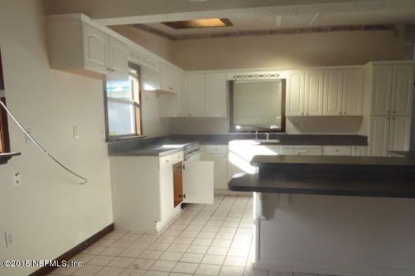 126 Pique Road Crescent City, FL 32112 - Photo 18 of 20 a view of a kitchen with granite countertop a sink and a stove top oven