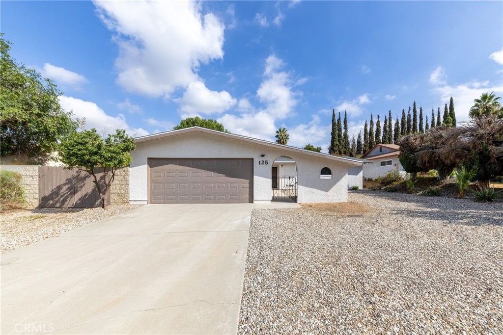 125 Brian Way Riverside, CA 92507 - Photo 1 of 1 a front view of a house with a yard and garage