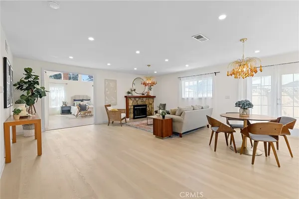 a view of a dining room with furniture and chandelier