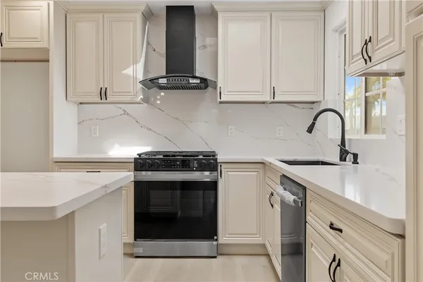 a kitchen with granite countertop a stove and a sink