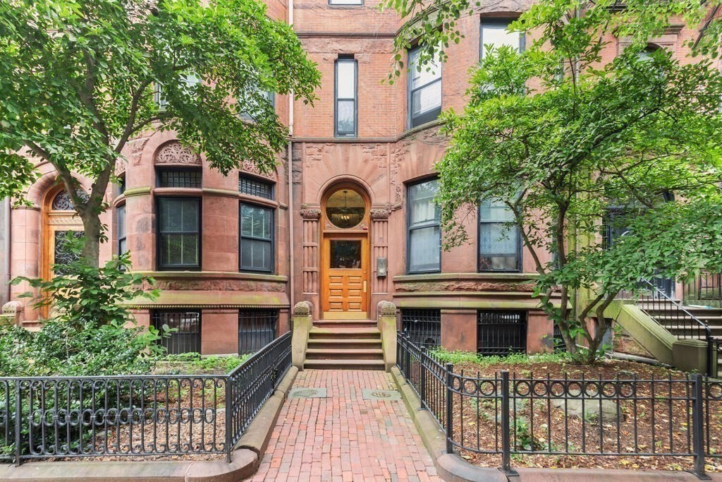 473 Beacon Street, Unit 5 Boston, MA 02115 - Photo 18 of 21 a front view of residential houses with yard