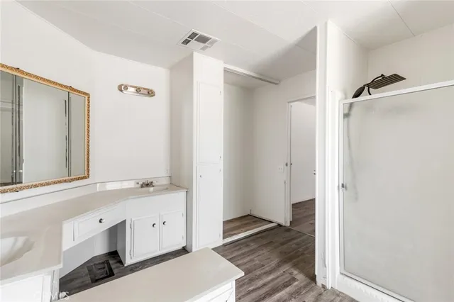 a view of a bathroom with a sink mirror and shower