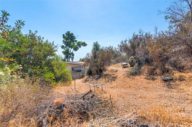 a view of house with backyard space