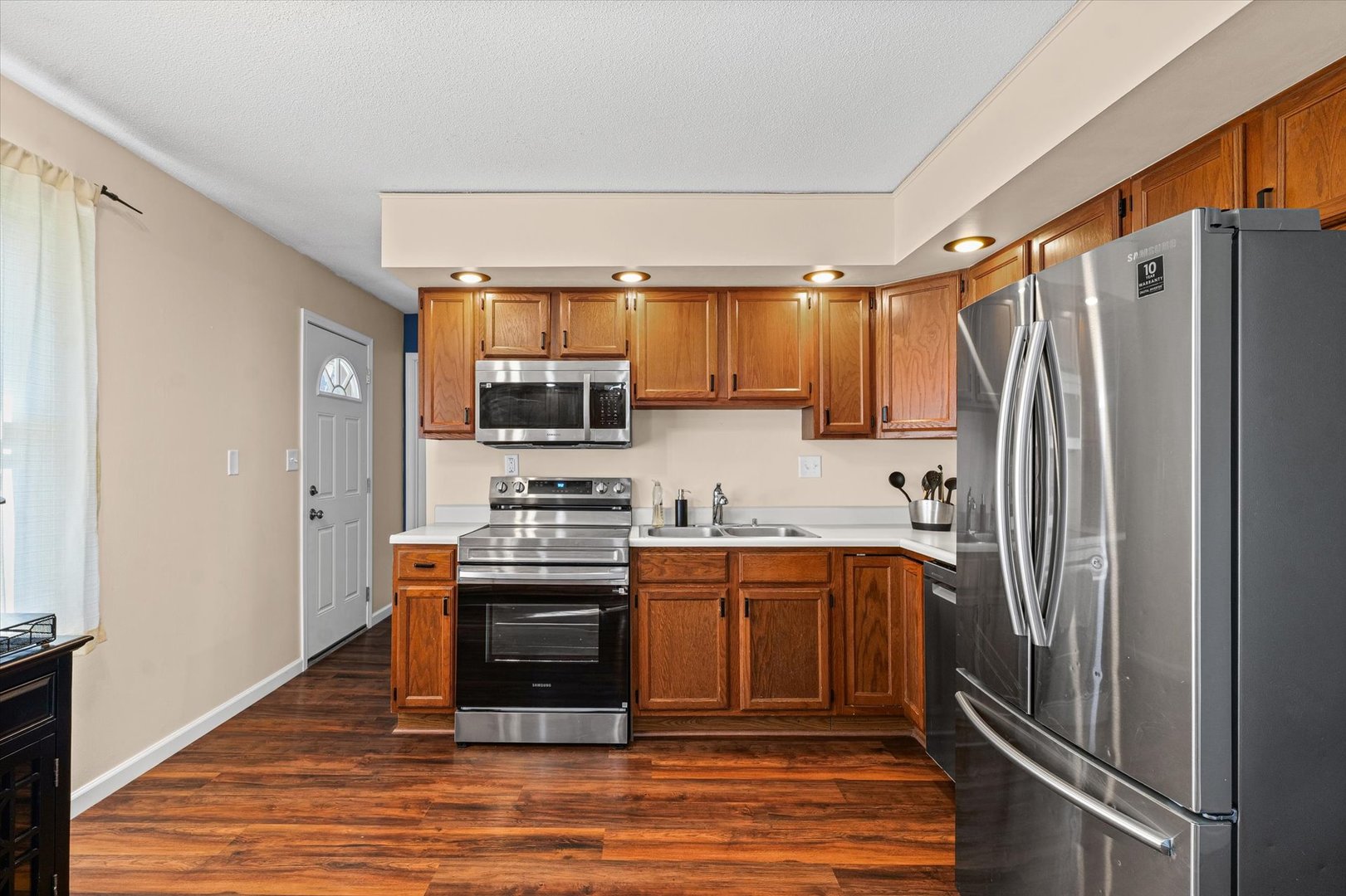 203 Valley Road Monticello, IL 61856 - Photo 12 of 25 a kitchen with stainless steel appliances granite countertop a refrigerator and a stove top oven