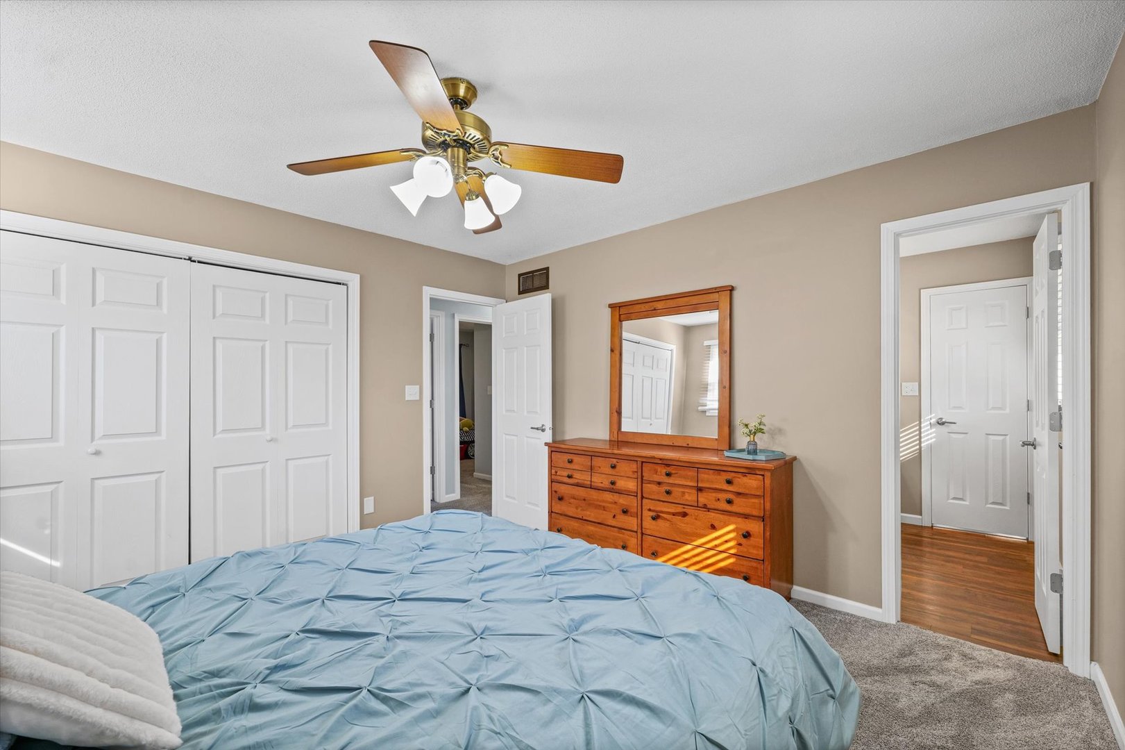 203 Valley Road Monticello, IL 61856 - Photo 14 of 25 a bedroom with a bed and a chandelier