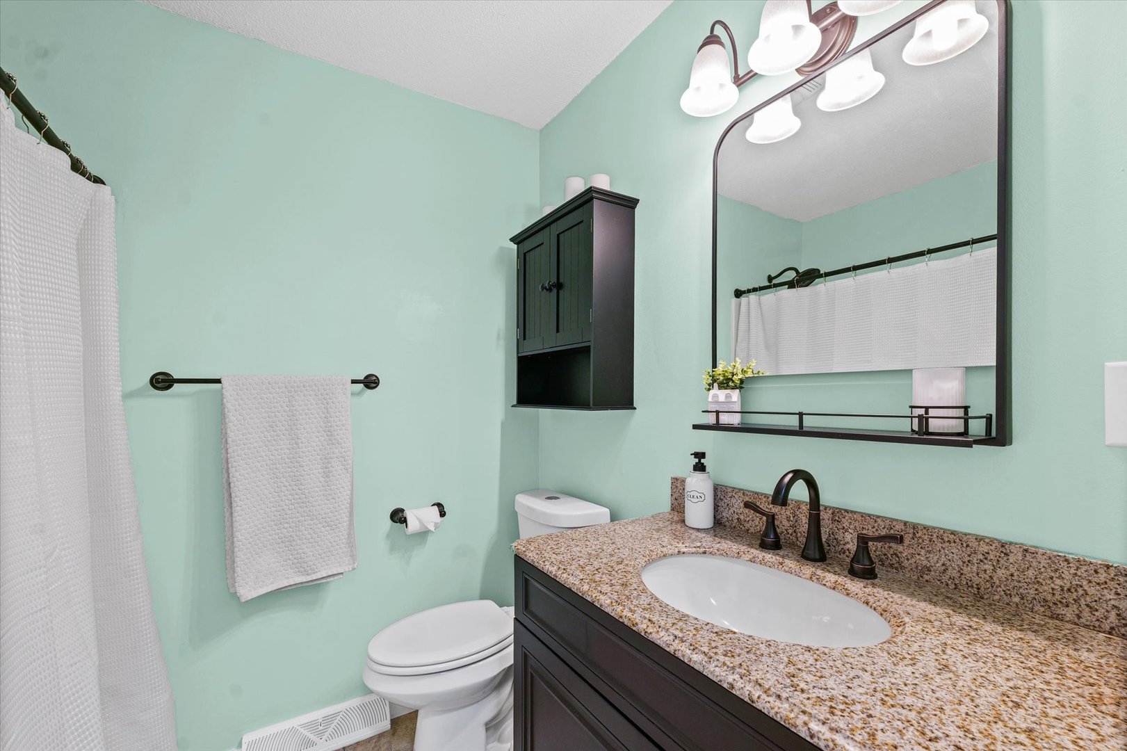 203 Valley Road Monticello, IL 61856 - Photo 18 of 25 a bathroom with a granite countertop sink a toilet and a mirror