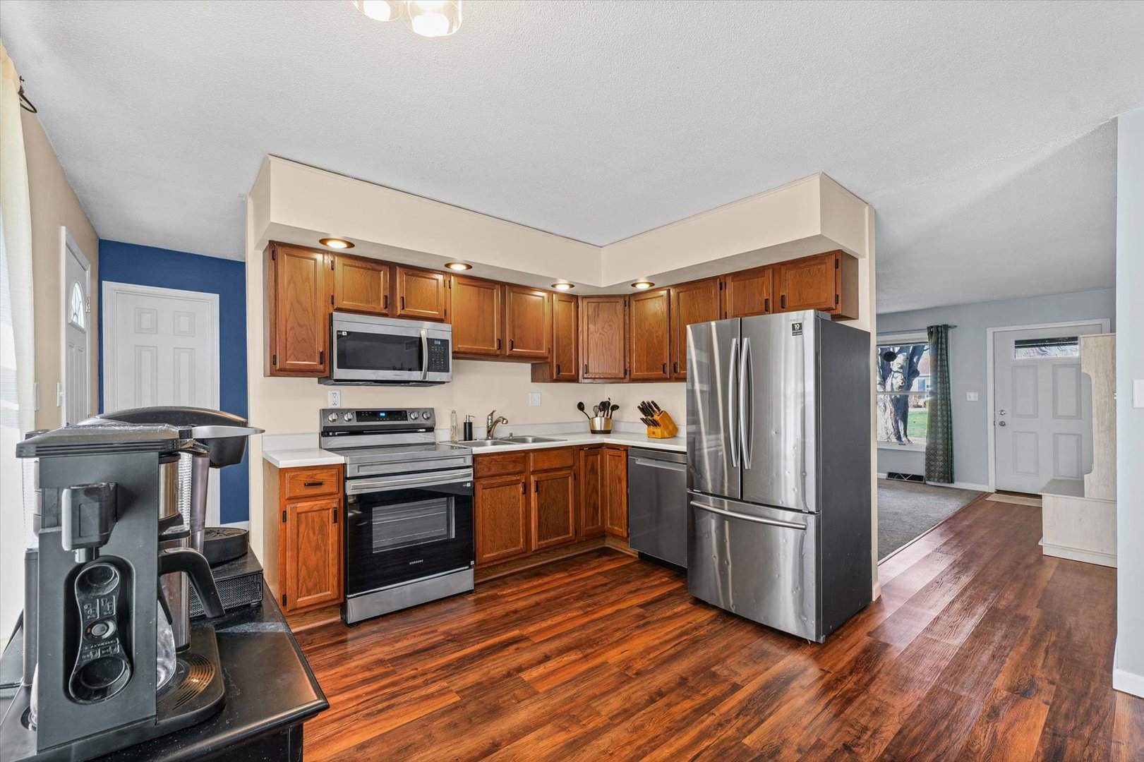 203 Valley Road Monticello, IL 61856 - Photo 9 of 25 a kitchen with stainless steel appliances a refrigerator stove and wooden cabinets