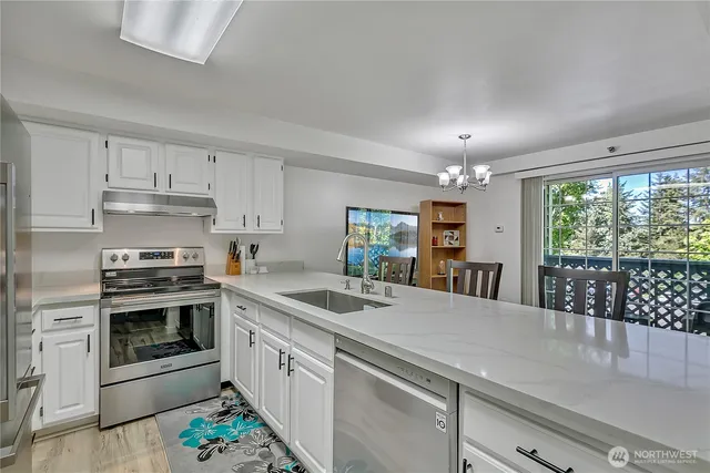 a kitchen with a stove sink and microwave