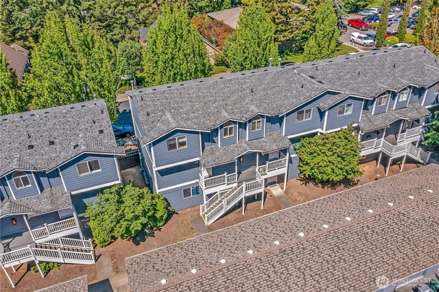 an aerial view of a house with a yard and plants